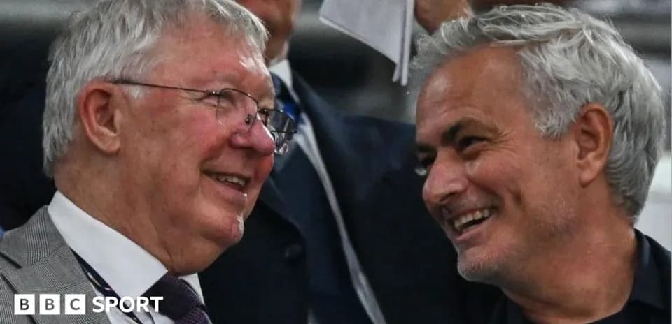 Two men smiling and chatting in a crowd