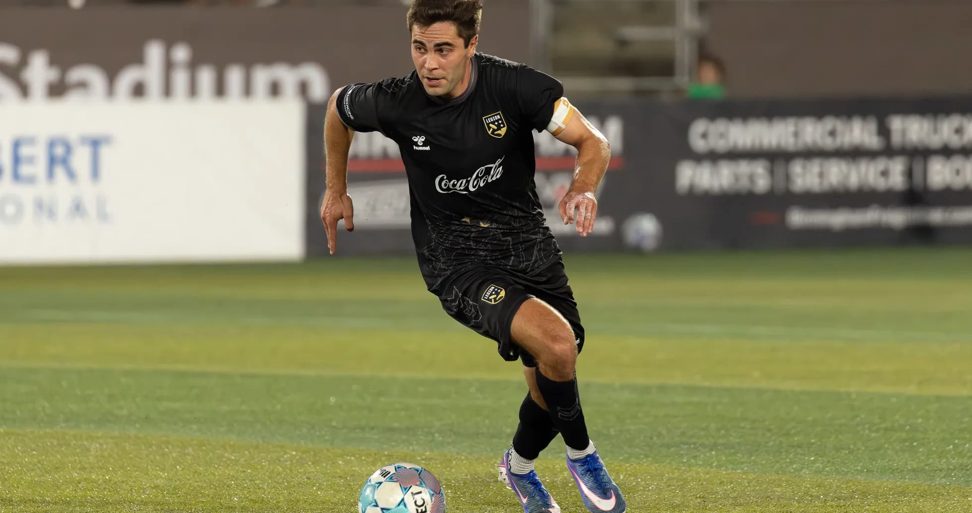 Player dribbling ball during football match