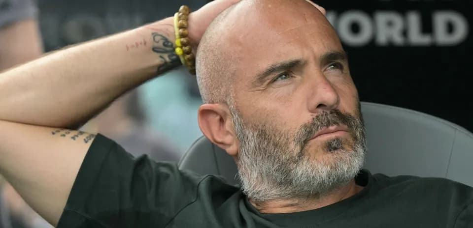 Coach sitting on the bench during match