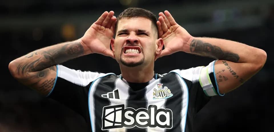 Player celebrating with hands to ears after goal