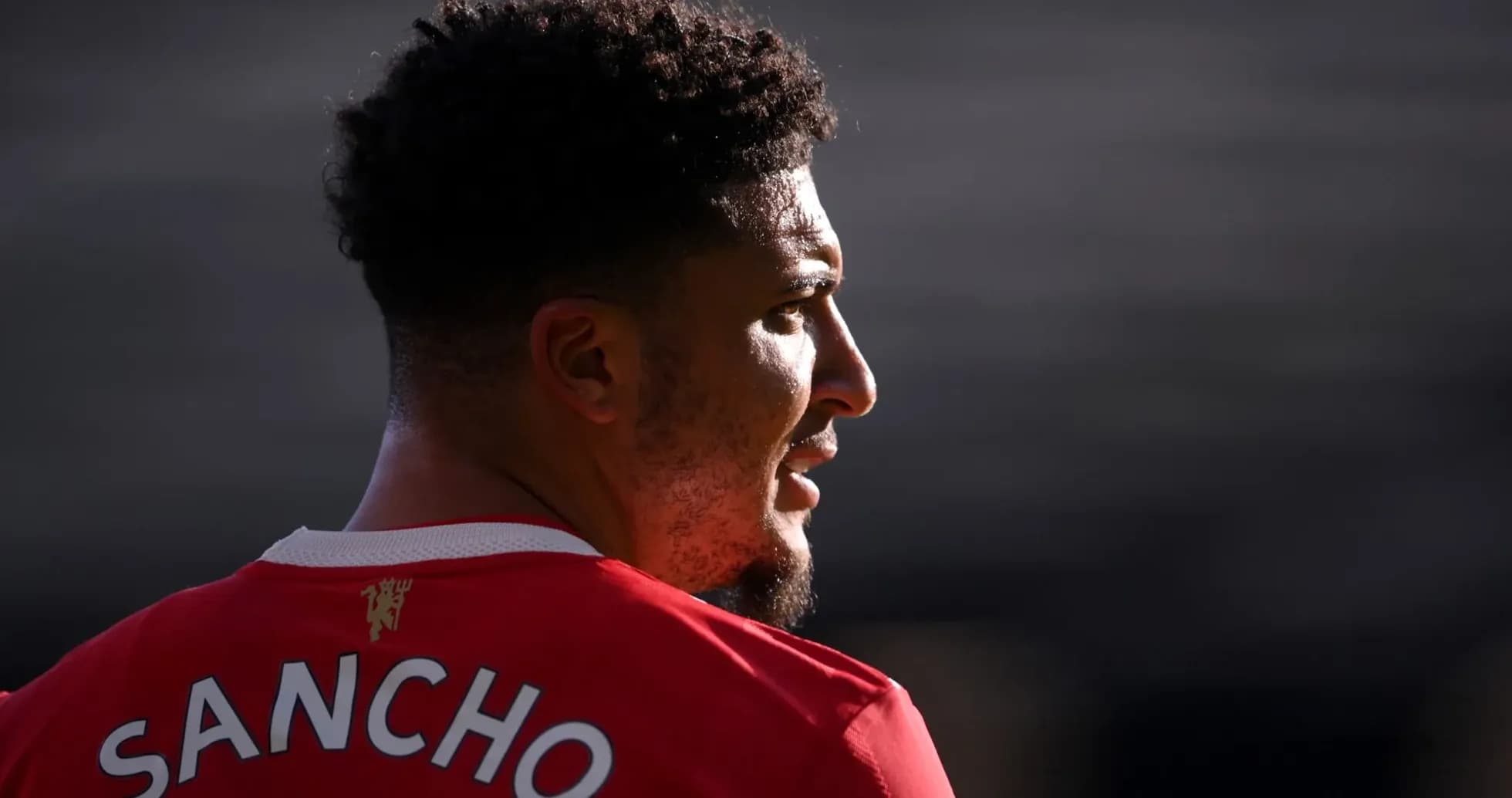 Player wearing Manchester United jersey, profile view