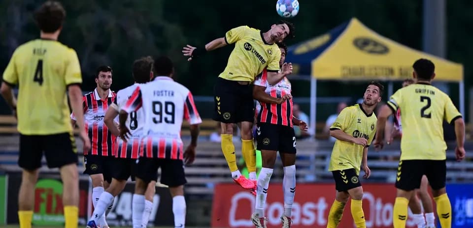Player jumping for header during Charleston Battery match