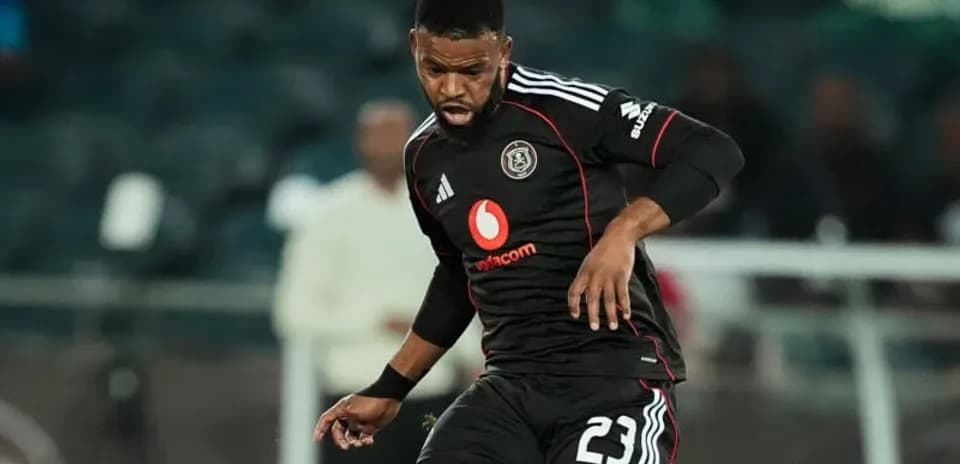 Player in black kit dribbling during match
