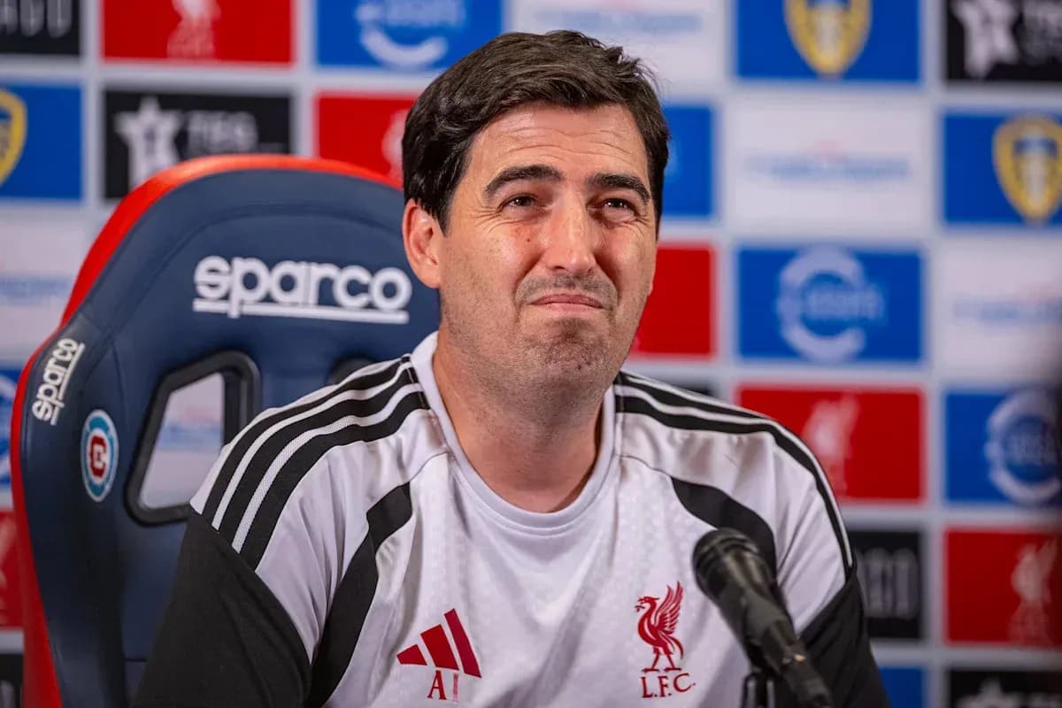 Manager speaking at press conference with Liverpool logo