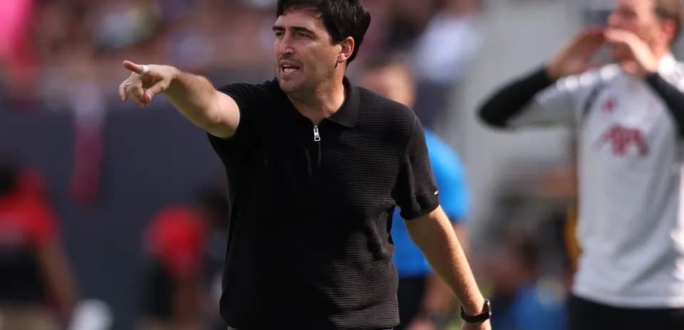 Coach directing players during a match on the sidelines