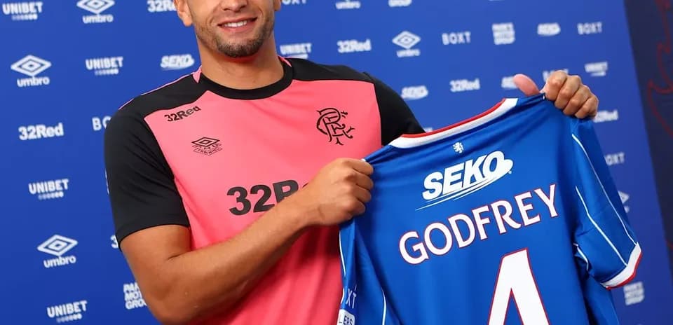 Player holding new jersey at club announcement