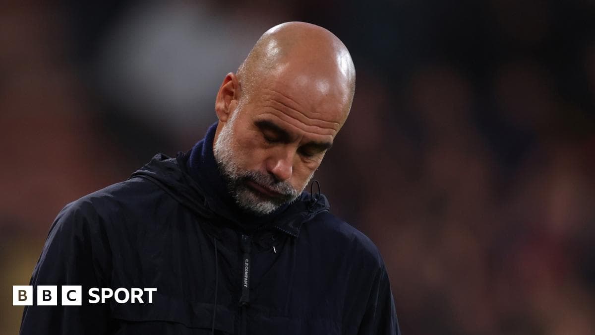 Manager looking down during match on sidelines