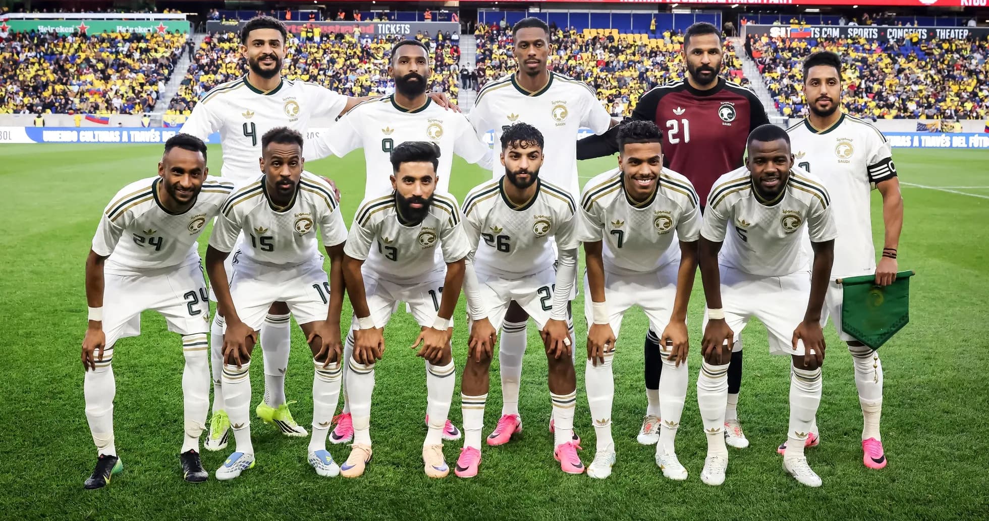 Soccer team posing for group photo on field