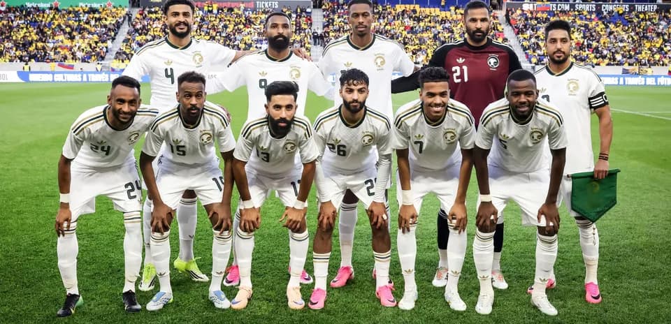 Soccer team posing for group photo on field