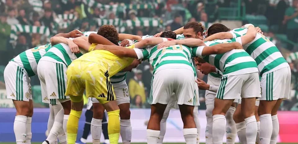Celtic players huddled together before the match