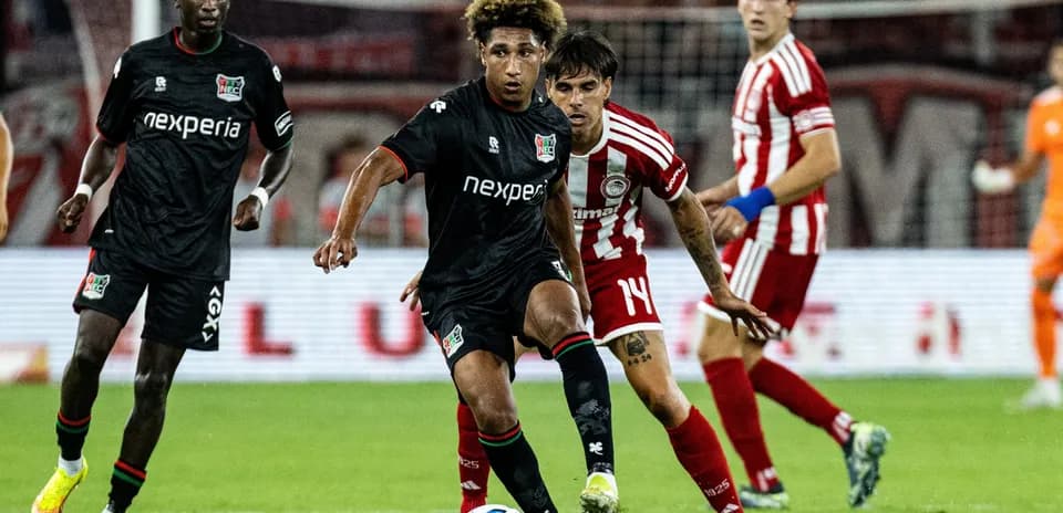 NEC player dribbling against Olympiakos defenders