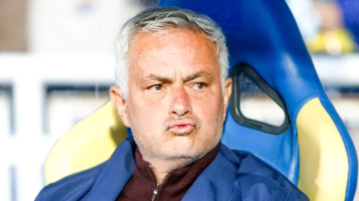 Coach seated on bench during match
