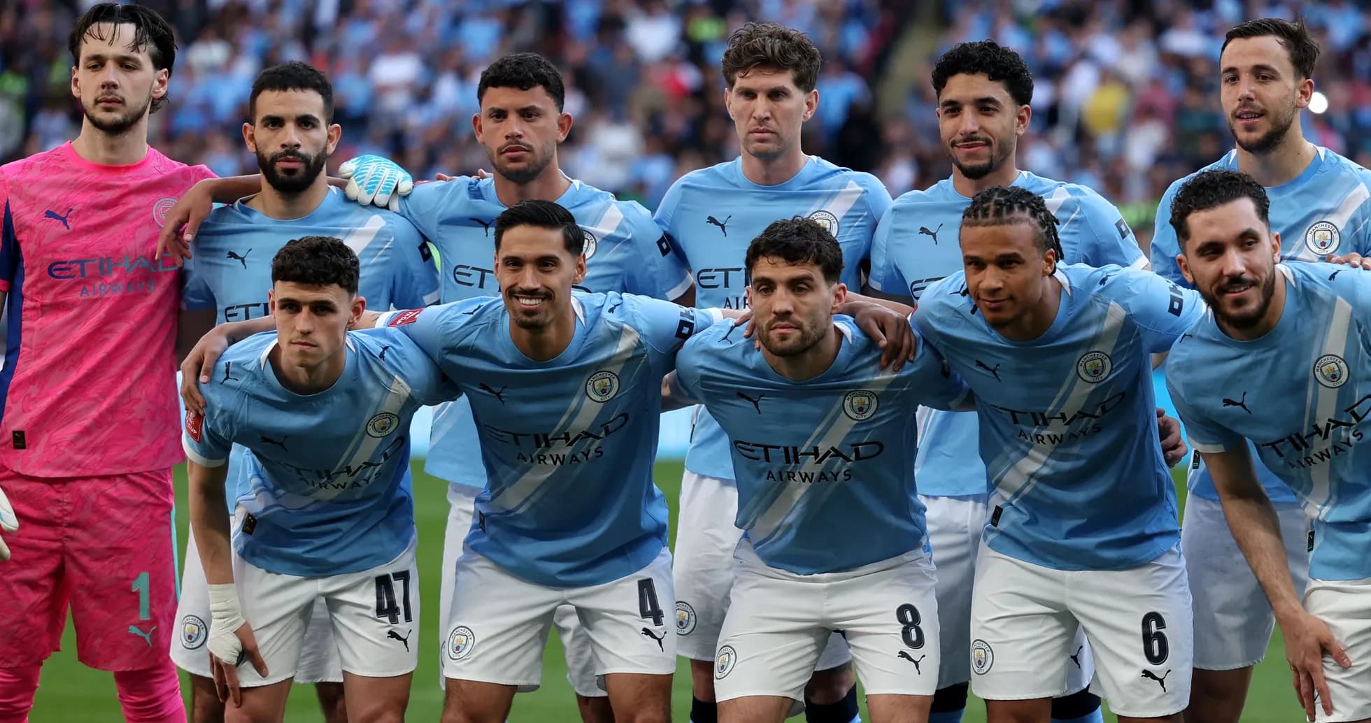 Manchester City team posing before the match