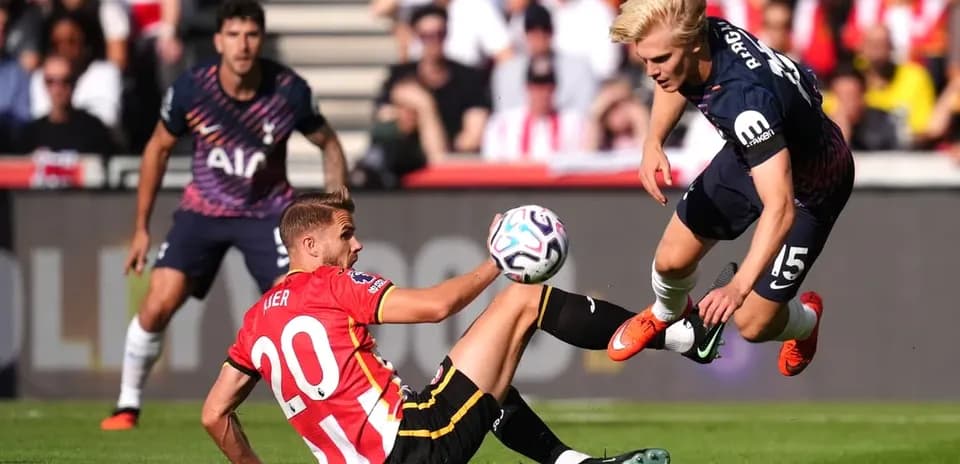 Player sliding to tackle during football match