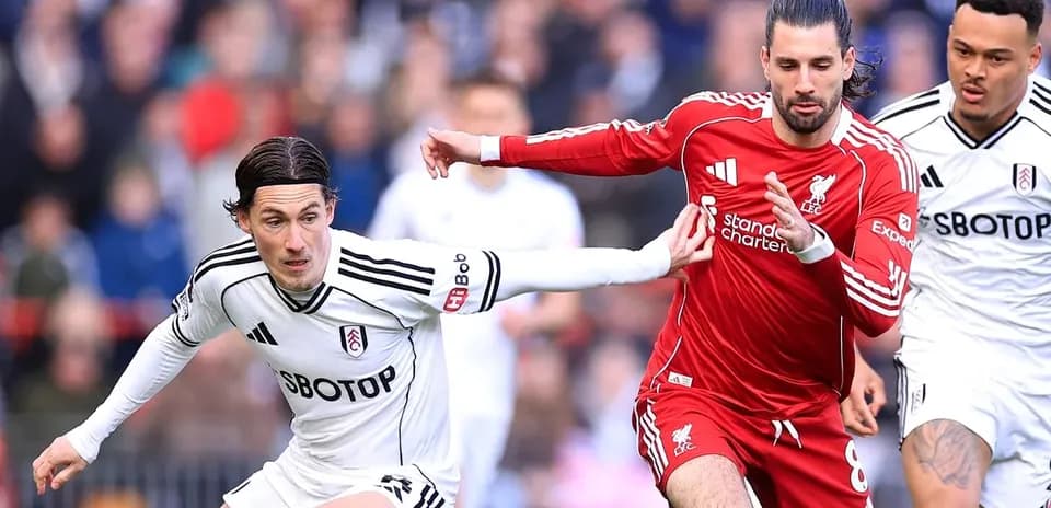 Fulham and Liverpool players contesting for the ball
