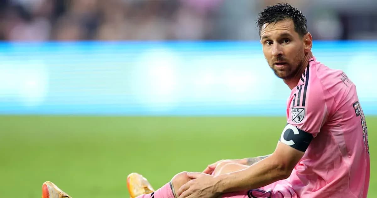 Player sitting on the field in pink jersey