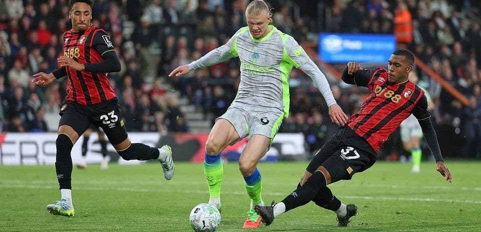 Erling Haaland challenged by Bournemouth defenders
