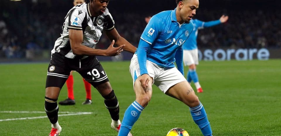 Napoli player being challenged by Udinese player