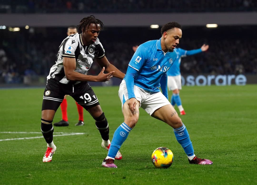 Napoli player being challenged by Udinese player
