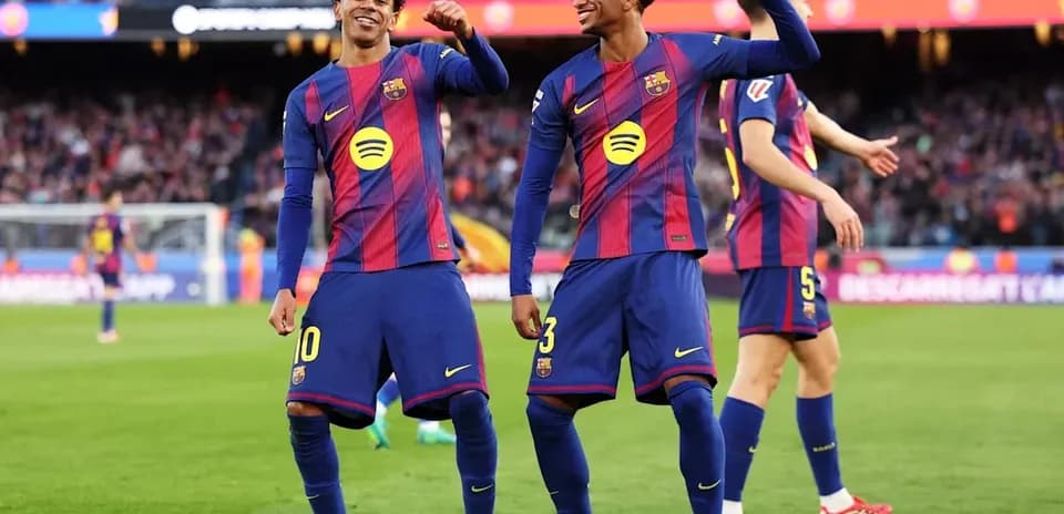 Two Barcelona players celebrating on the pitch