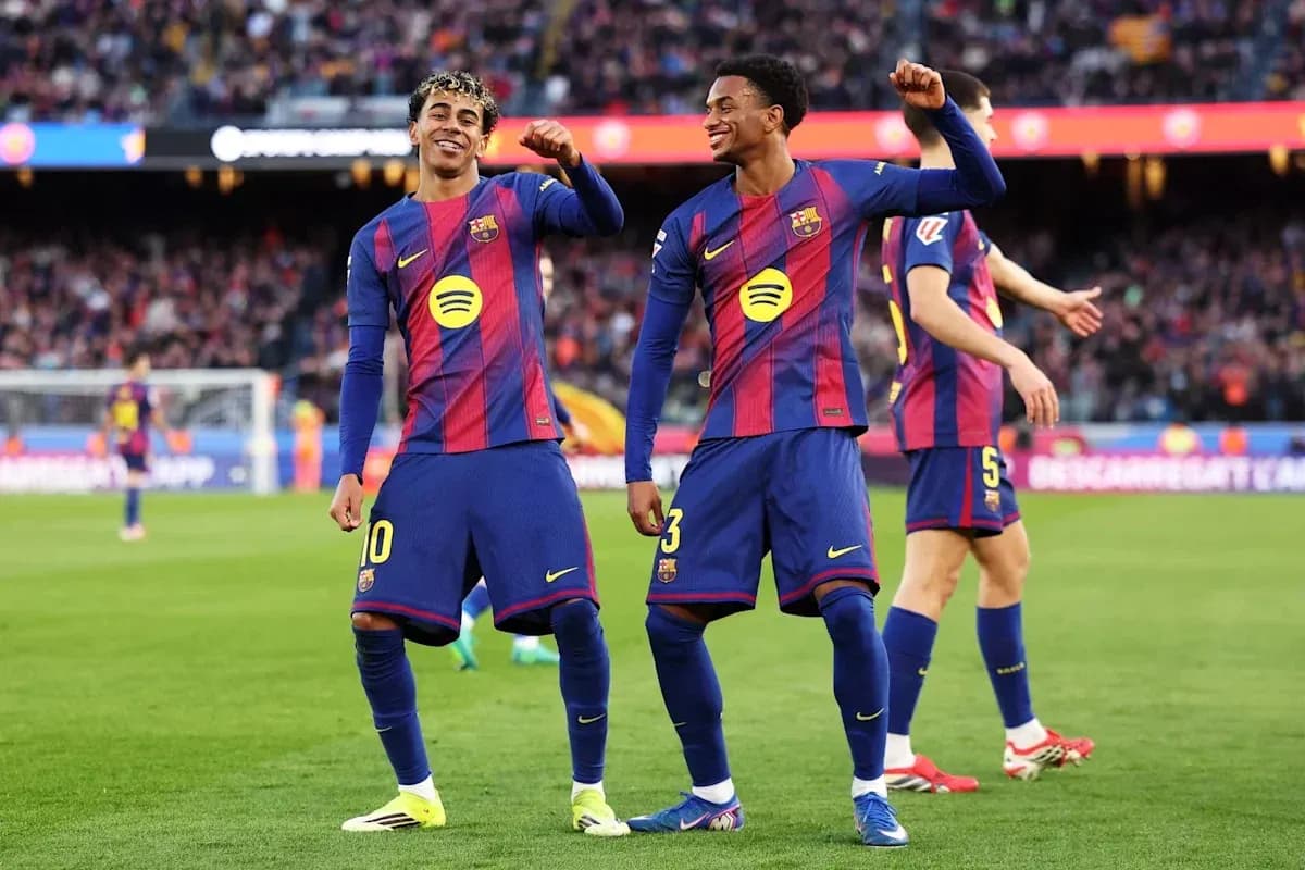 Two Barcelona players celebrating on the pitch