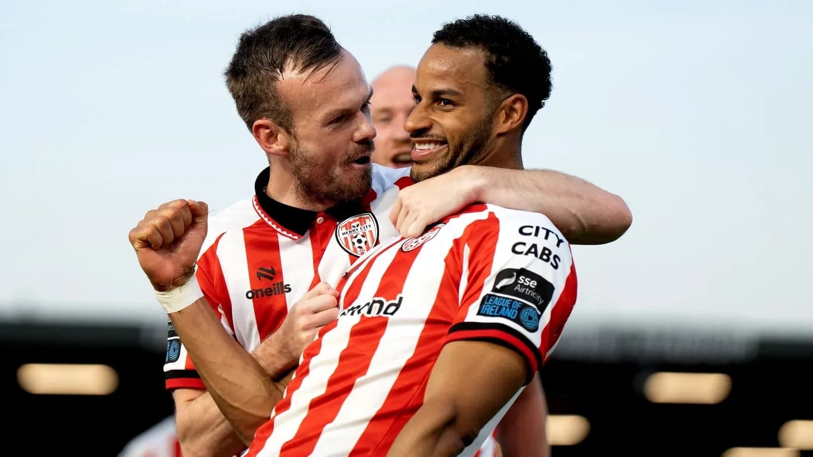 Two players celebrating a goal on the field