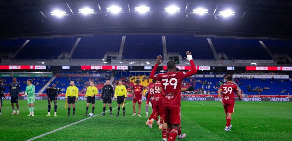 Players greeting fans before the match