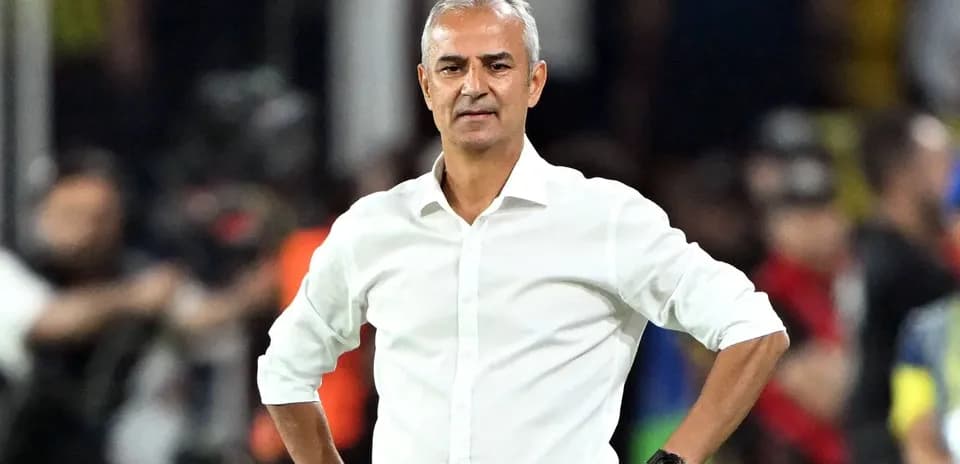Coach standing with hands on hips during match