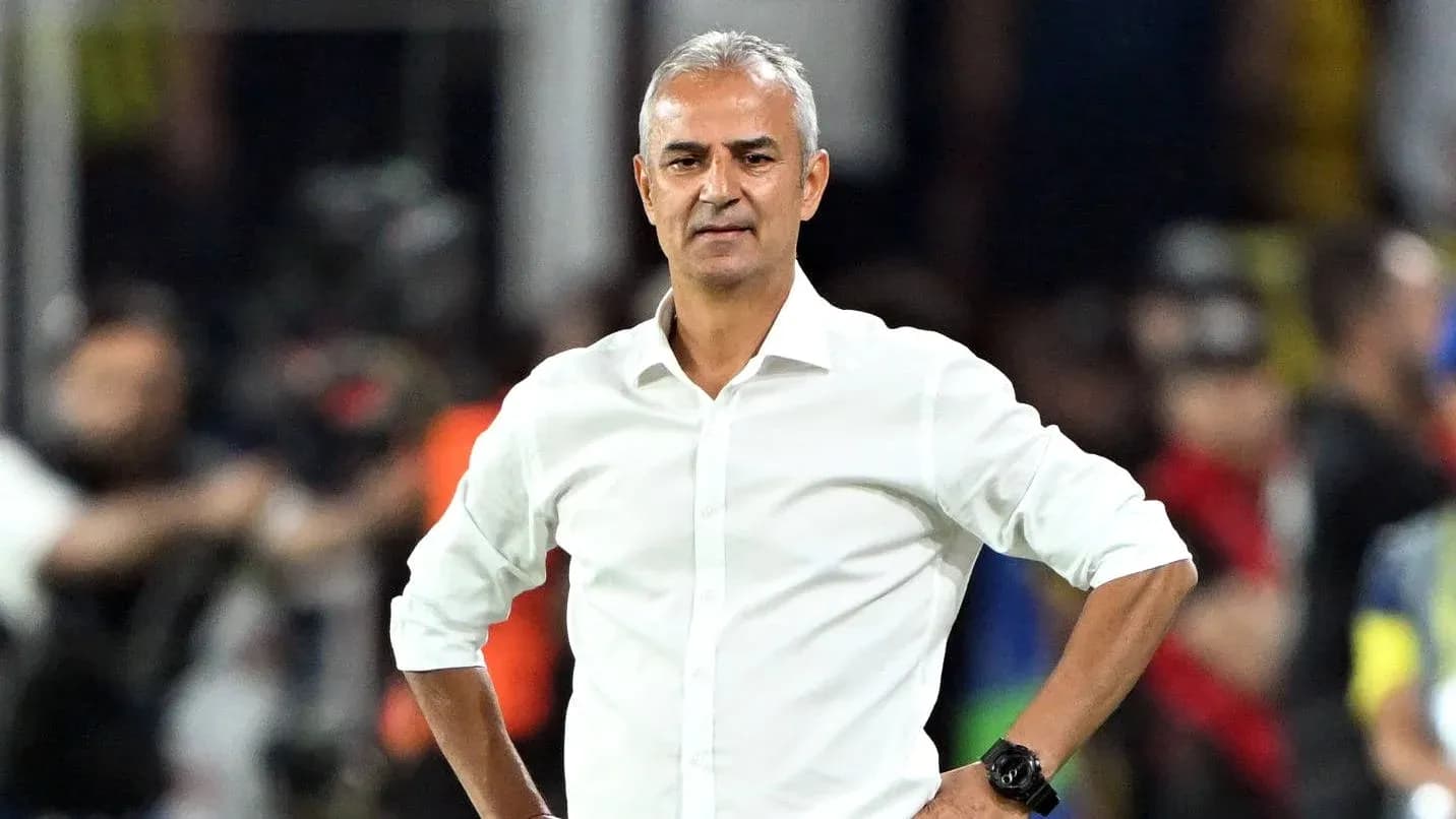 Coach standing with hands on hips during match