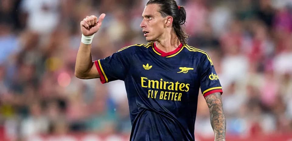 Player gesturing during match in Arsenal jersey