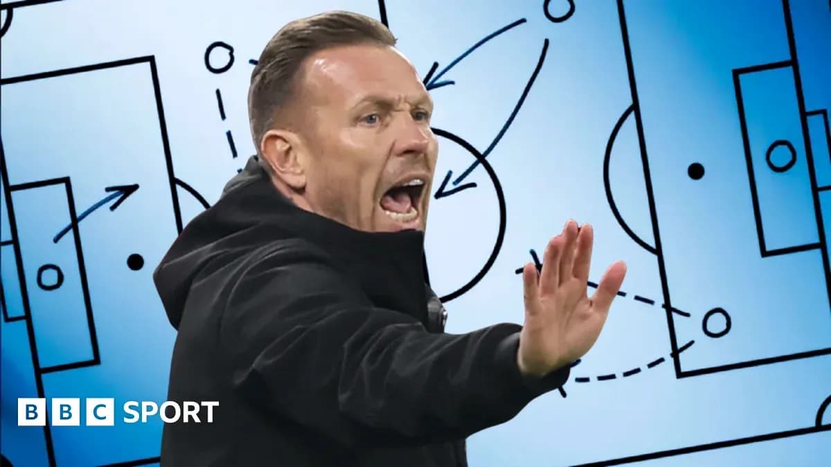 Coach gesturing during tactical discussion on screen