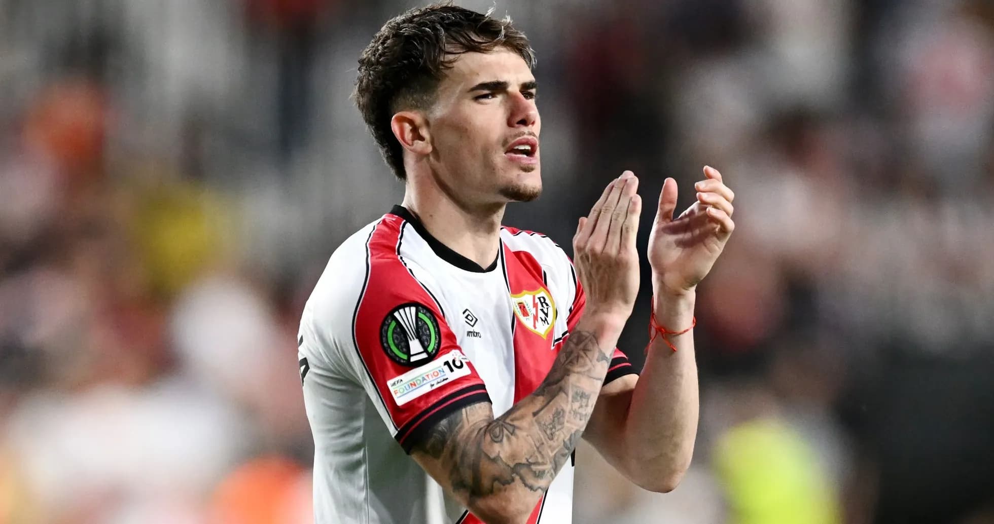 Player clapping in Rayo Vallecano jersey during match