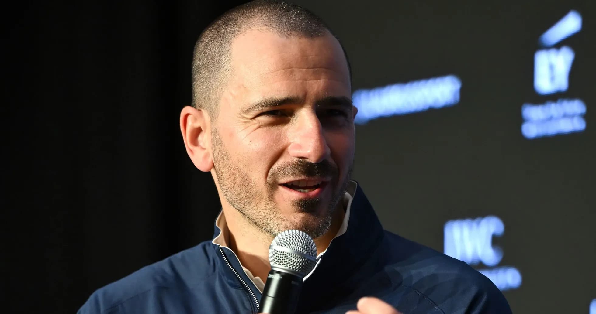 Speaker holding microphone at event podium