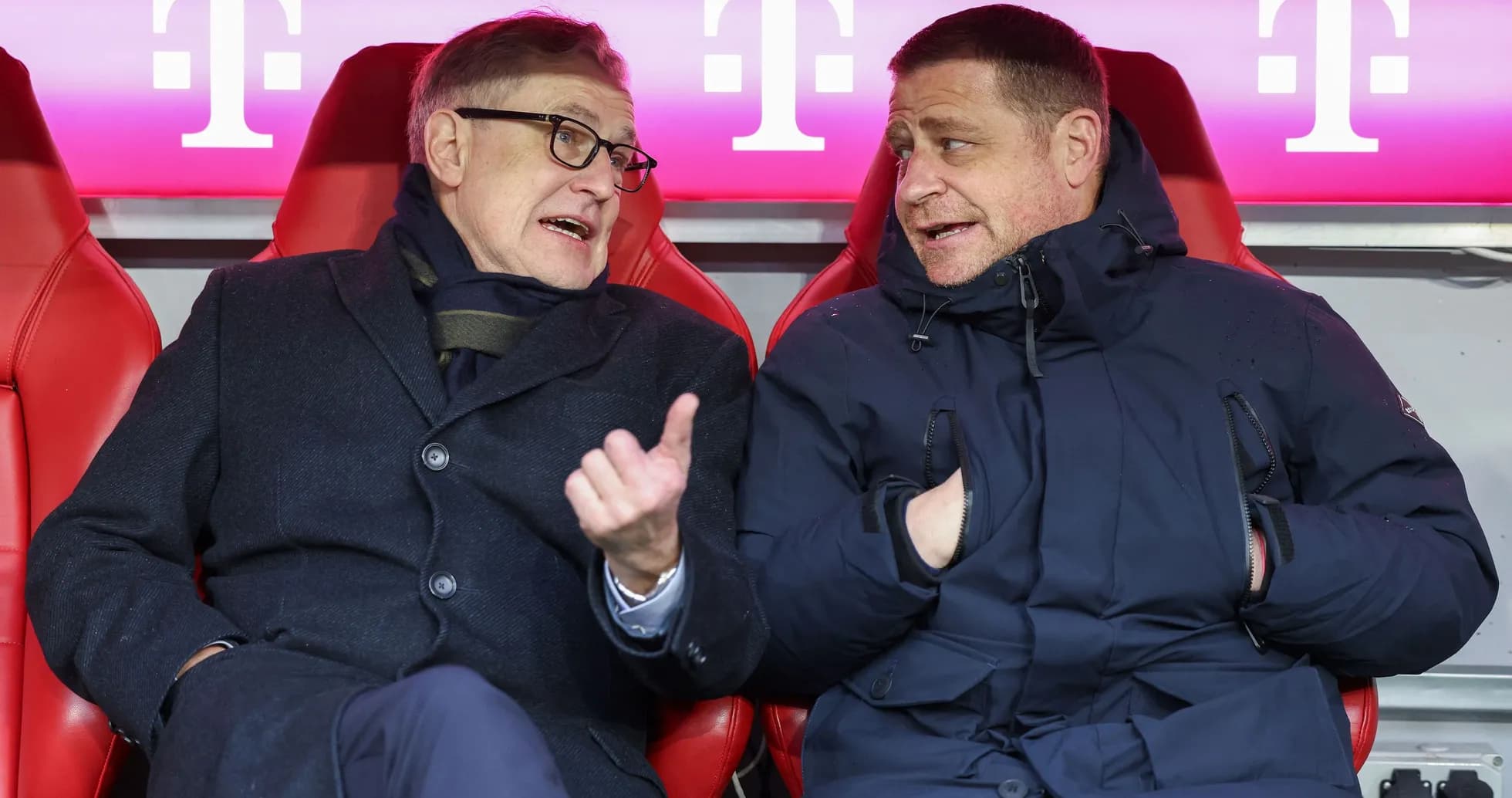 Two men talking on the bench during a match