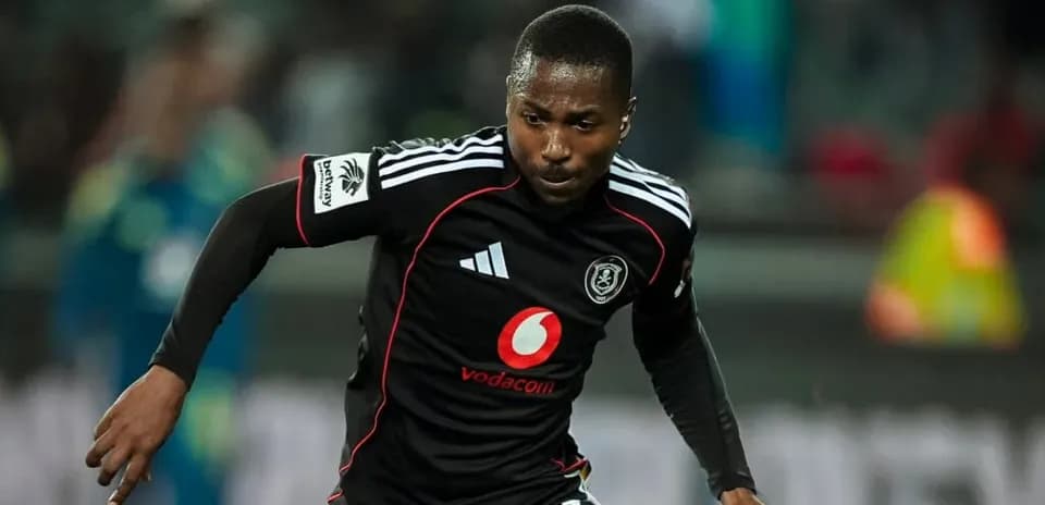 Player in black jersey running during a match