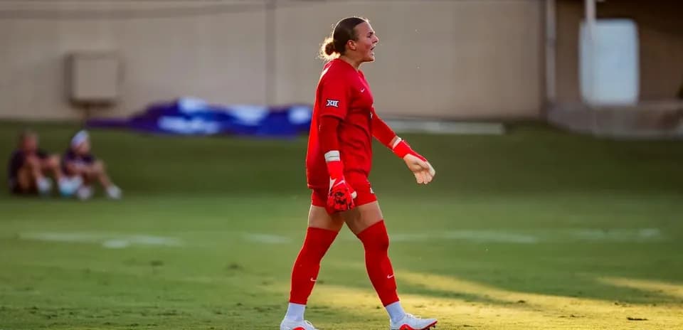 Goalkeeper in red uniform during soccer match