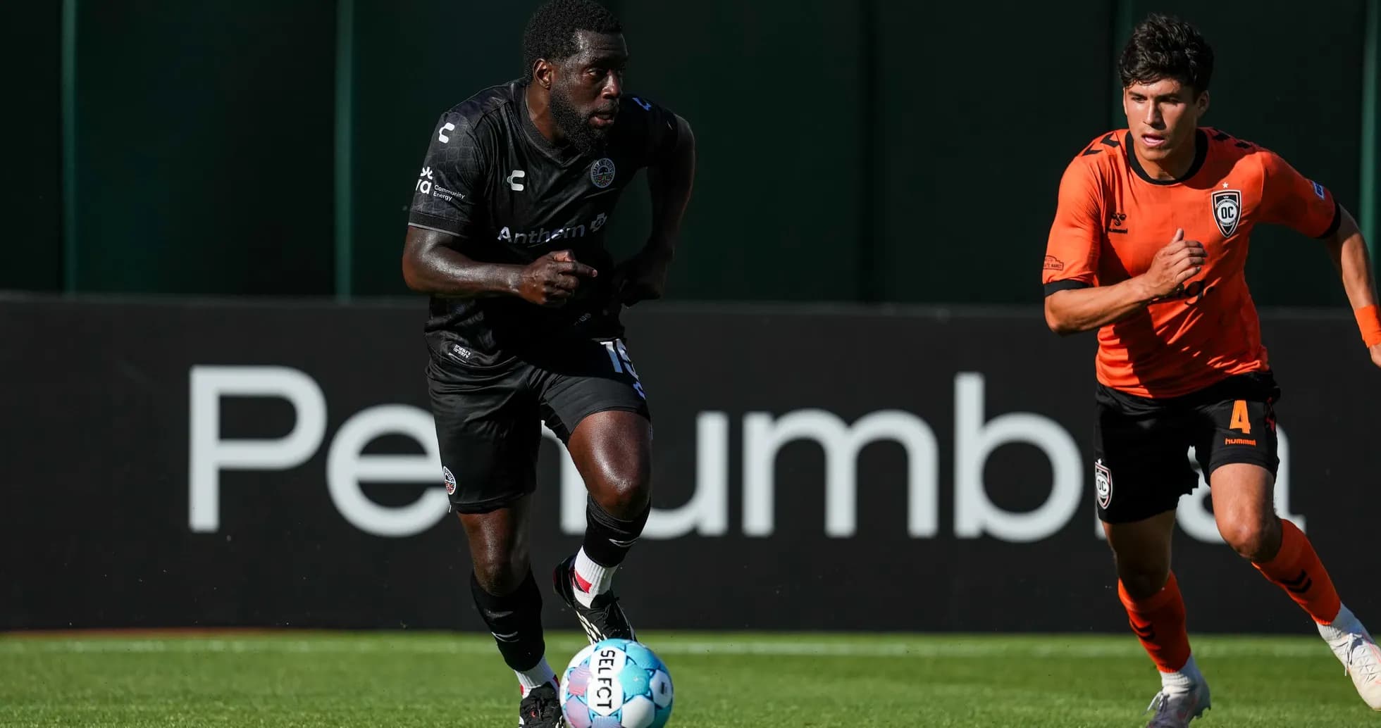 Player running with ball during football match