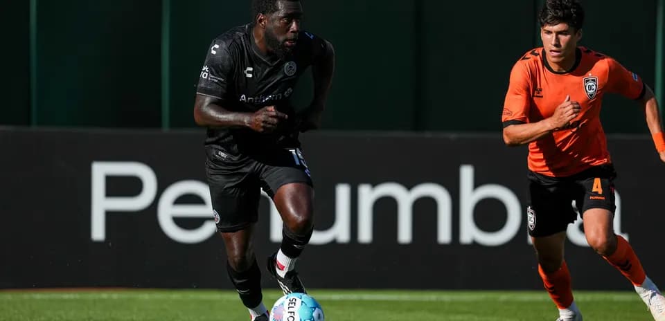 Player running with ball during football match