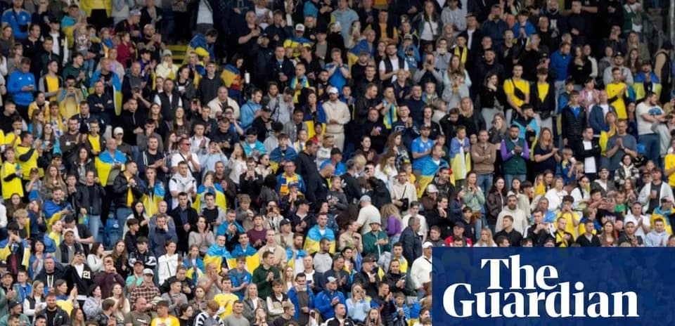 Crowd of fans in stadium supporting their team