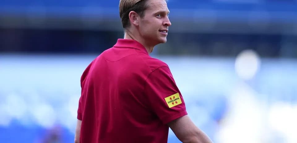 Coach wearing red shirt at stadium sidelines
