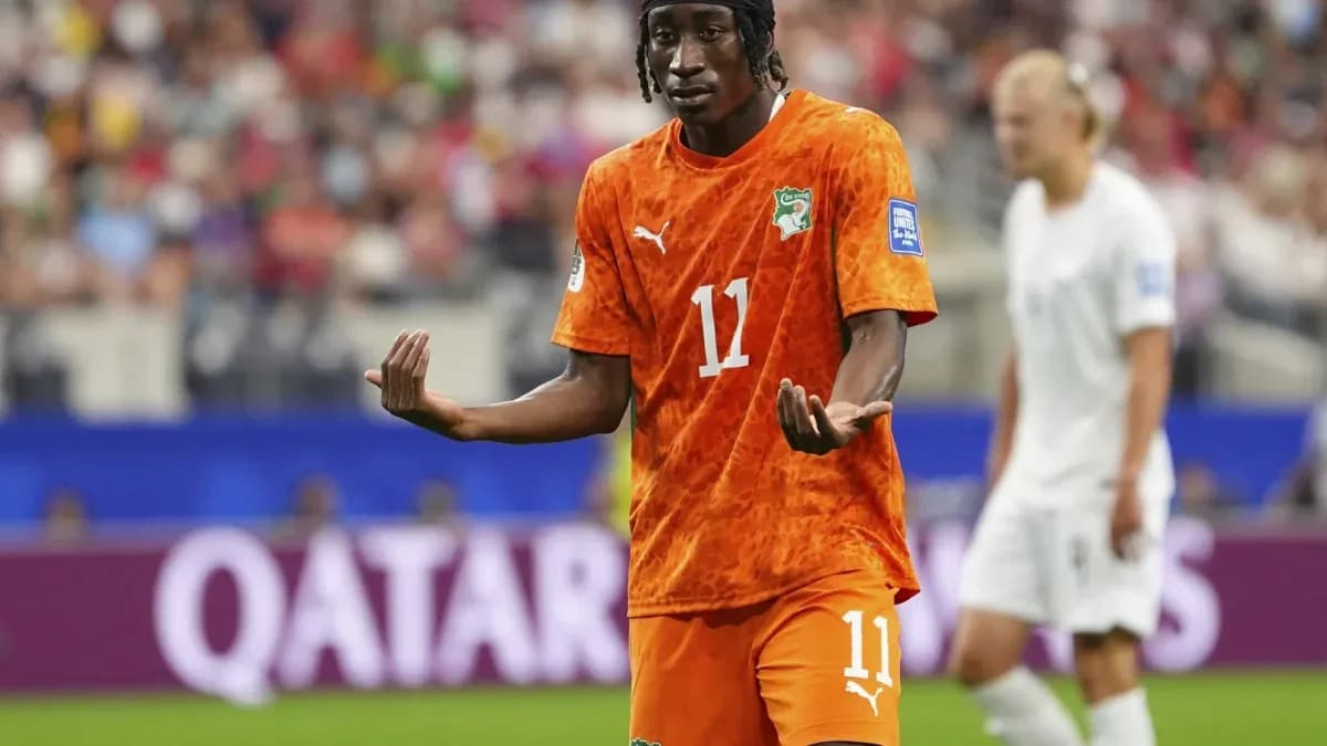 Player gesturing during a match in orange jersey