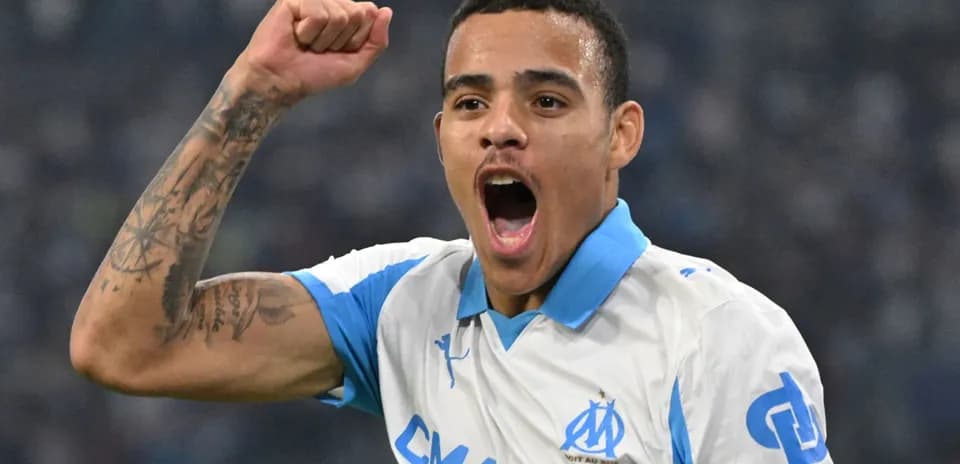 Player celebrating with raised fist in Marseille jersey