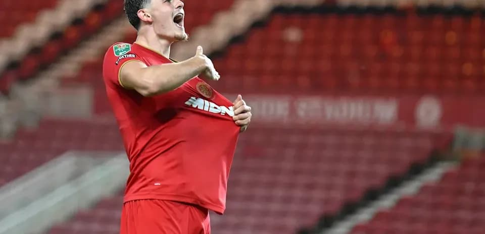 Player celebrating and lifting shirt after scoring
