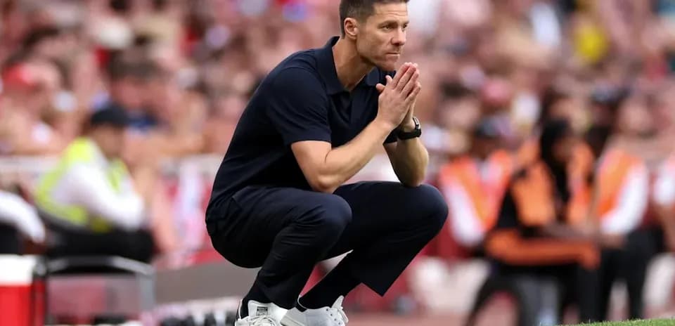 Coach observing the match while crouching on sidelines