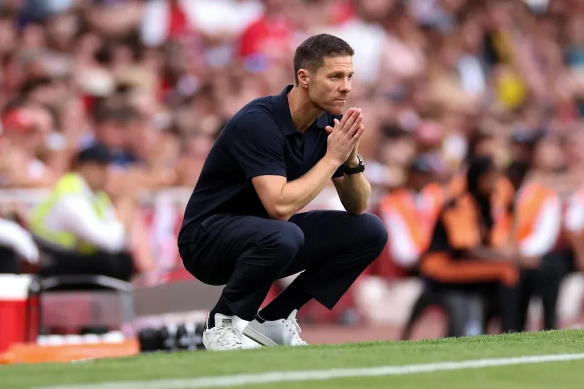 Coach observing the match while crouching on sidelines
