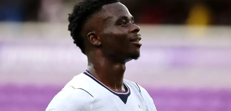 Player in England kit smiling during match