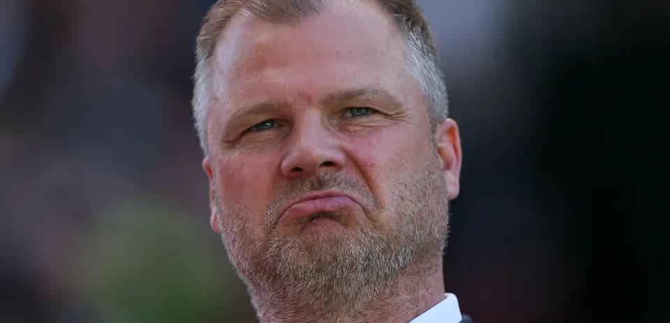 Coach with a serious expression on the sidelines
