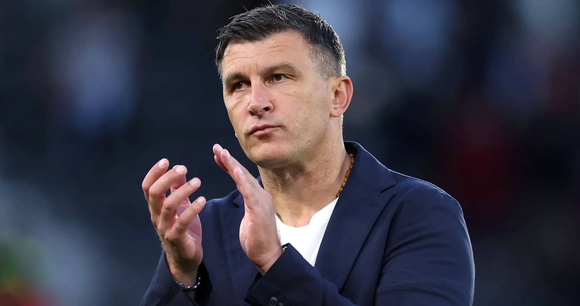 Coach gesturing and applauding during match