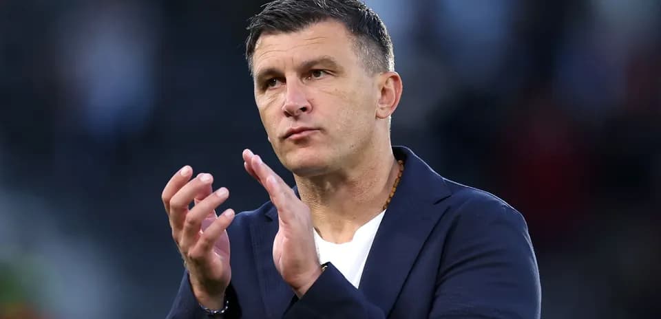 Coach gesturing and applauding during match
