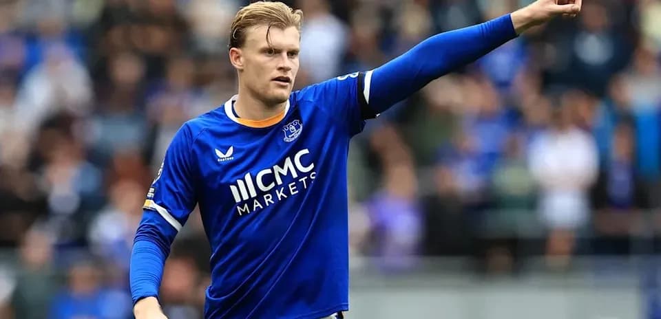 Player gesturing during match in blue jersey